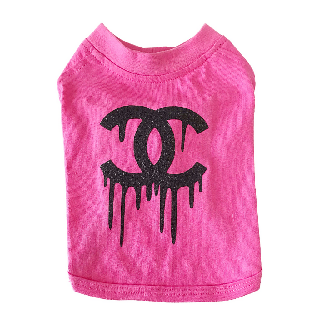Pink dog shirt with black dripping logo on a white background