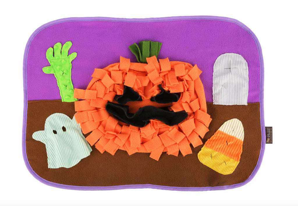 Halloween-themed plush toy with a pumpkin, ghosts, and candy corn on a purple background