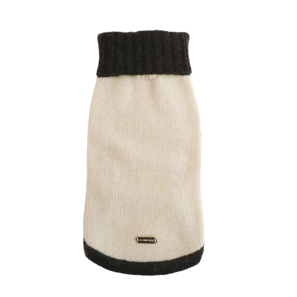 Knitted dog sweater with black trim on a white background