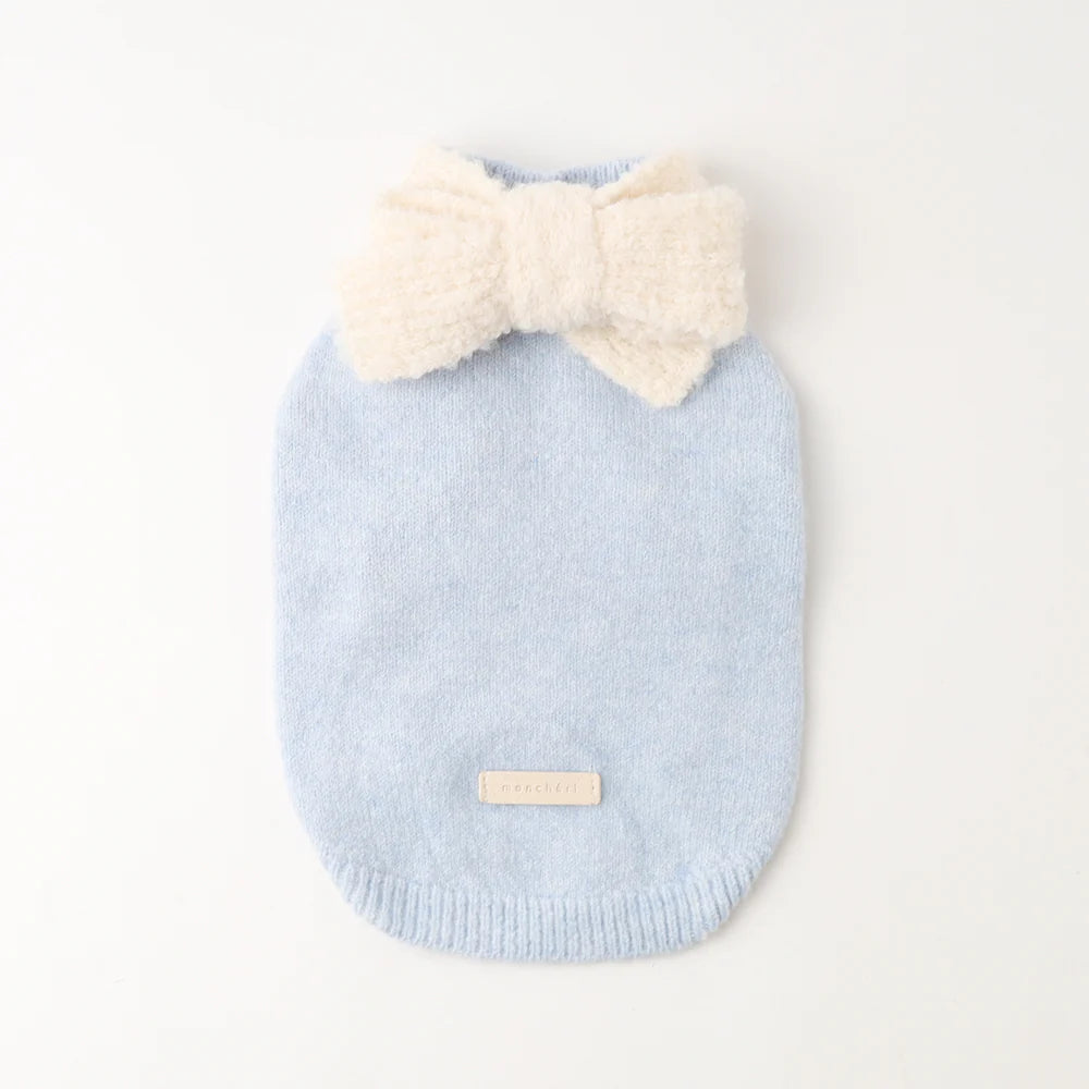Light blue knitted dog sweater with a cream bow on a white background