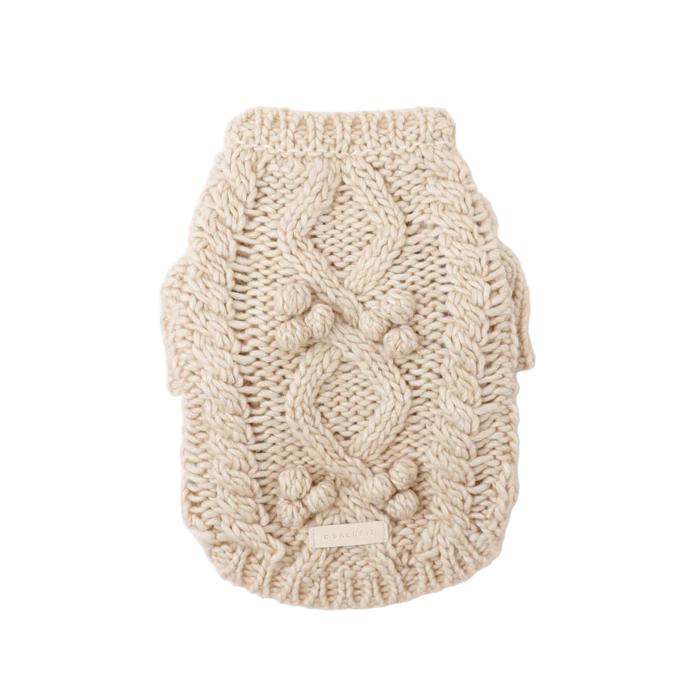 Knitted dog sweater with cable pattern on a white background