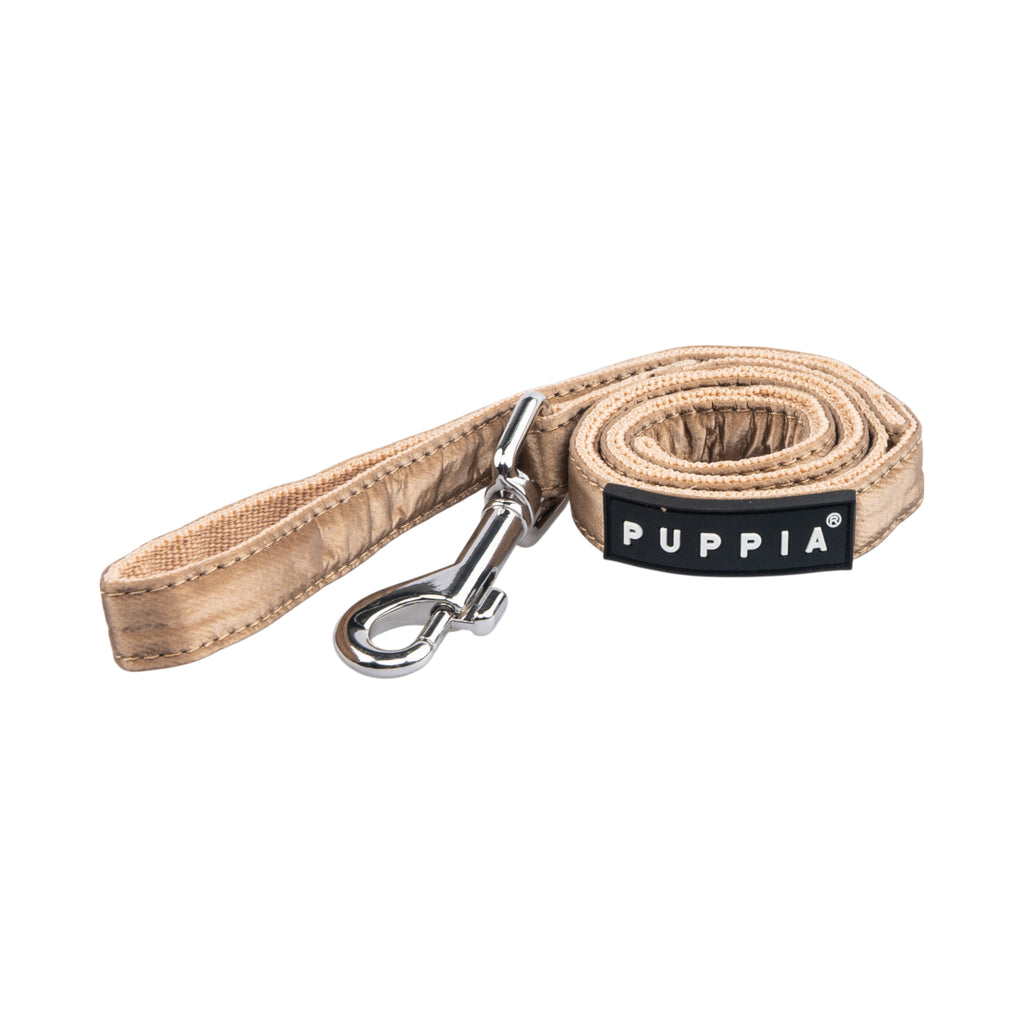 Beige dog leash with metal clip and Puppia label on a white background