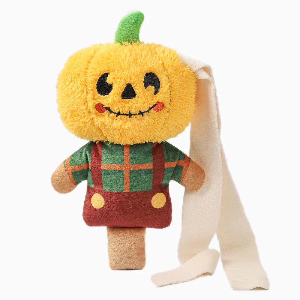 Plush toy with pumpkin head and green stem, wearing a red outfit with a green shirt, on a white background.