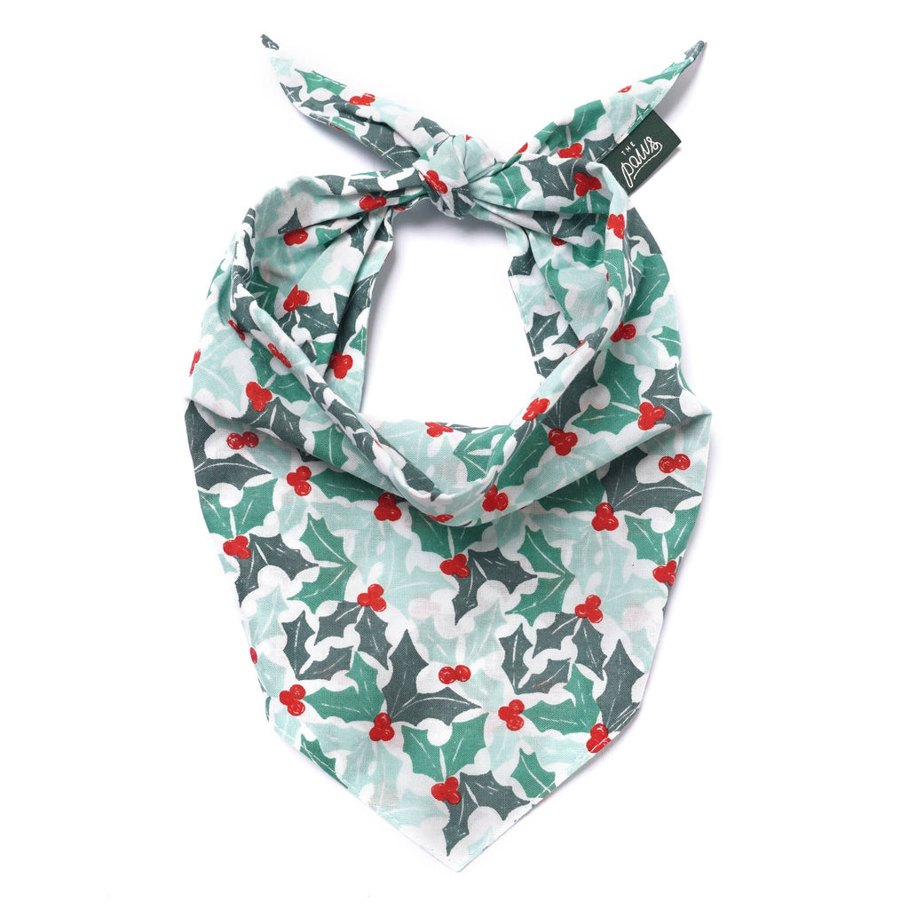 Christmas-themed bandana with holly design on a white background