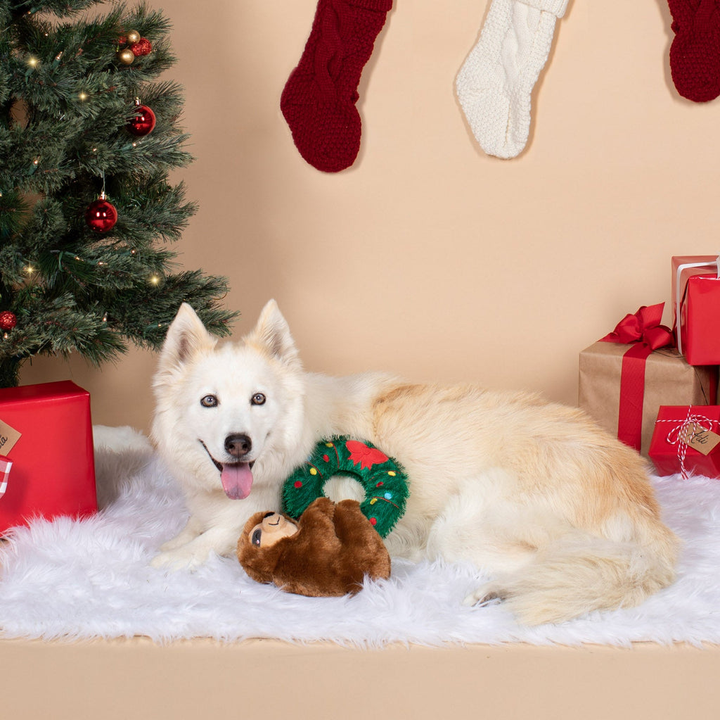 sloth hanging from a wreath plush toy